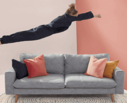 woman jumping onto couch
