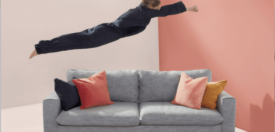 woman jumping onto couch